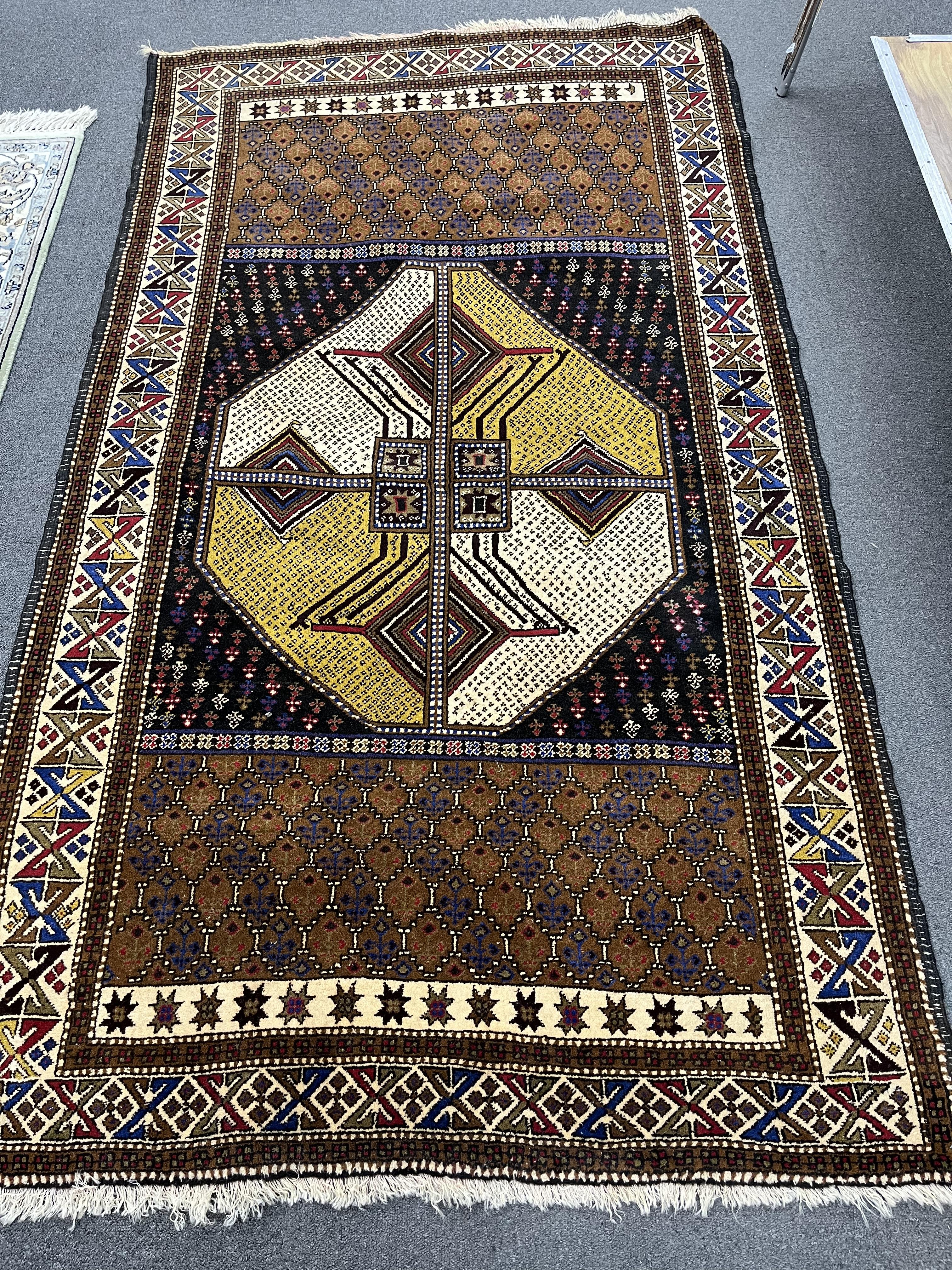 A Belouch geometric polychrome rug with central octagonal medallion, 202 x 113cm